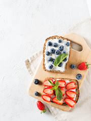 Strawberry and blueberry toast on breakfast on white background.