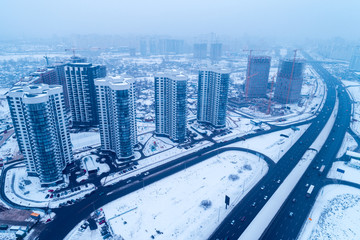 Skyline, commuter town, Kiev city in blizzard. Aerial view of Left bank of the Dnieper River 