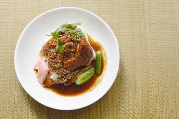 roasted duck meat topping rice dressing sweet sauce and pickled ginger on plate