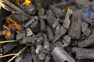 Burning coals at day; barbeque season, decaying charcoal.