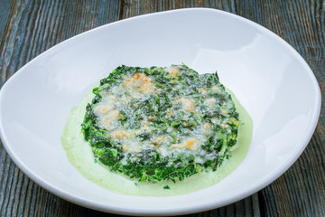 Spinach with cream and baked Parmesan cheese