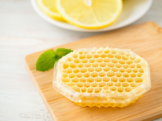 White Cup of tea, honey, honeycomb, lemon on white background. Folk method of treating colds, top view