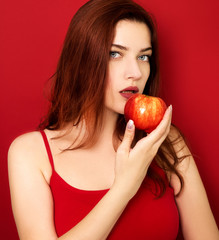 Young woman eating red apple