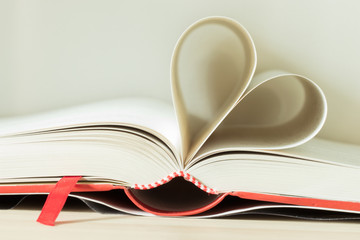 A book is a series of pages assembled for easy portability and reading, as well as the composition contained in it.