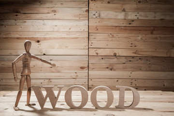wooden puppets with wood word on wood table in wood scene