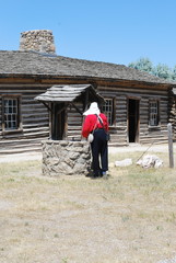 Calvary military soldier attending a water well outside.
