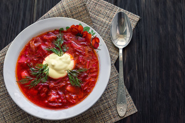 Borsch soup. borsch on a wooden table with a spoon. National dish of Ukraine. The concept is delicious food.
