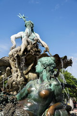 Neptune fountain from 1891 by Reinhold Begas with Greek god Poseidon and woman statue with fishnet and grapes represents river Rhine, Berlin, Germany