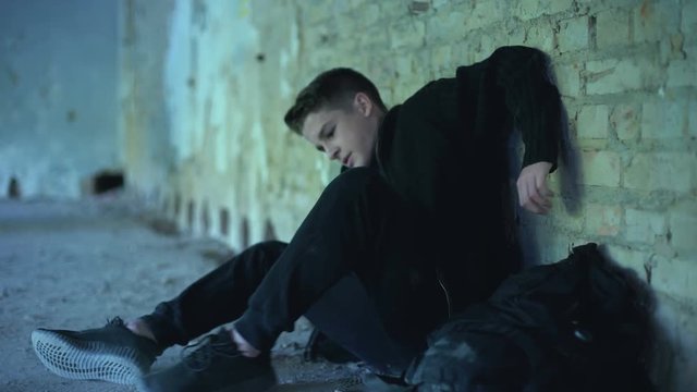 Teenage boy hiding in abandoned building, escaped from dysfunctional family