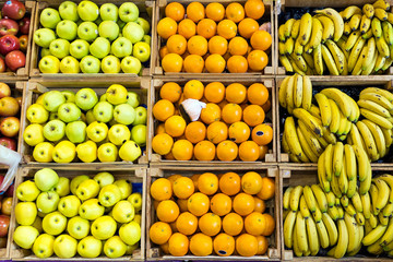 Different types of colorful fresh fruits in health grocery shop.