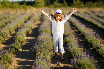 A Boy in a white hat having fun in lavender field