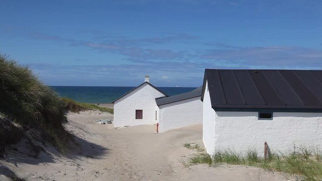 Stenbjerg is a fishing village on the former island of Thy in the northwest of Jutland, Denmark. It is noted for its small white fishermens huts next to the sandy beach.