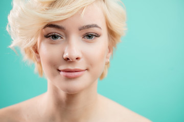 beautiful smiling blonde girl with stylish haircut and healthy soft face. spa salon concept. thick...