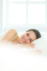 Obraz premium Beautiful girl sleeps in the bedroom, lying on bed.