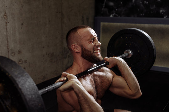 will power concept. muscular strong guy doing deadlift exercise at gym. close up cropped side view shot