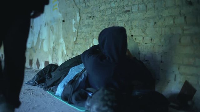 People passing by poor homeless young man, indifferent egoistic society, poverty