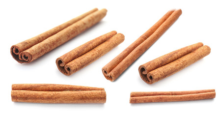 Set with aromatic cinnamon sticks on white background