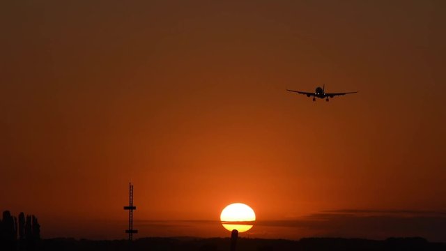 Airplane Airbus A330 landing at sunrise, medium light, with sound