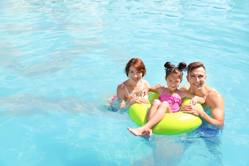 Happy family in swimming pool at resort