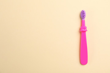 Manual toothbrush for child on color background, top view with space for text