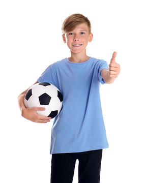 Portrait of young boy holding soccer ball on white background