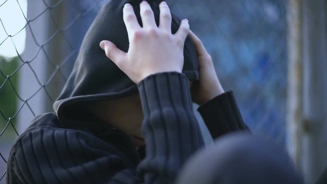 Teenage boy crying, school bullying, dysfunctional family, loneliness depression