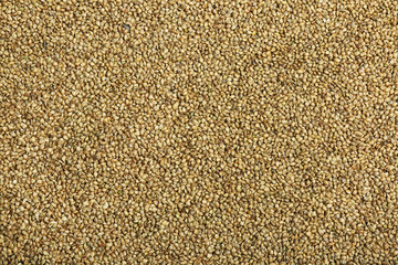 Raw hemp seeds as background, top view
