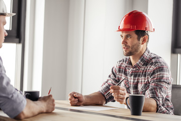 attractive businessman has made a decision which helps to develop the building company.