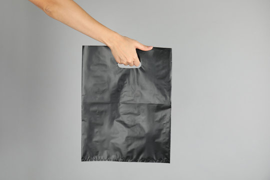 Woman with plastic bag on grey background. Mock up for design
