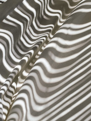 Shadow pattern lines on white wavy cloth, fabric