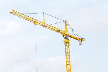 Construction tower cranes against blue sky background