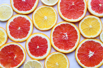 Background from slices of different oranges and lemons .