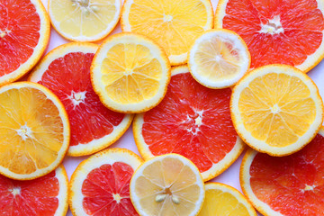 Background from slices of different oranges and lemons .