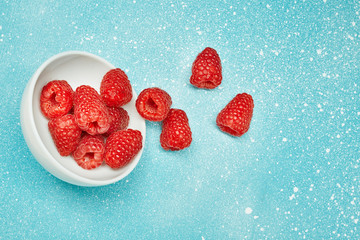 Fresh red raspberry on color background. Ingredients for cooking. Top view.