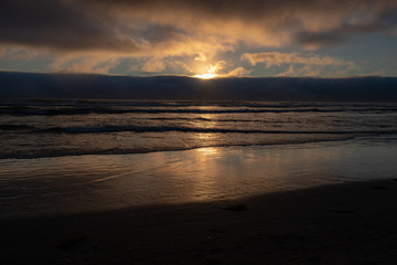 Fototapeta na wymiar Waves Rolling in at Sunset on the Pacific Ocean in Cannon Beach Oregon Northwest Coast USA