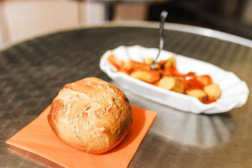 Curry wurst or bratwurst sausage with mustard sauce, local german street food cuisine