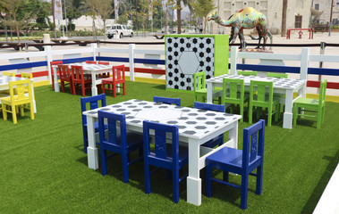 A playground for children with plastic furniture of bright colors. Children's plastic furniture. A table and chairs.