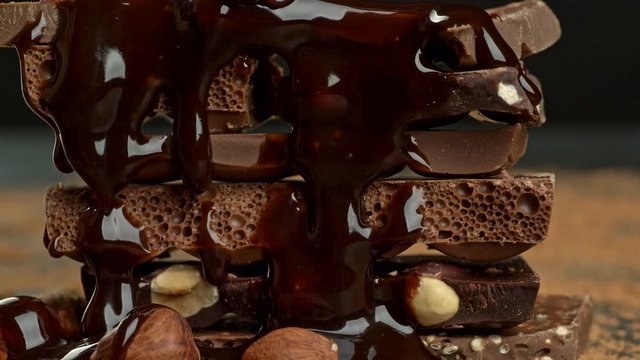 Stack of various chocolate pieces and nuts. High quality UHD shot.