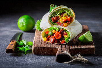 Spicy burrito made of lettuce and vegetables with red salsa