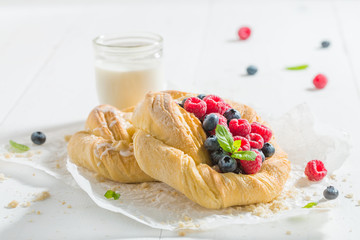 Sweet yeast cake with fresh berry fruits and milk