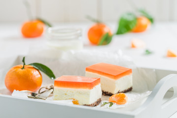Closeup of homemade cheesecake with fresh mandarin and jelly