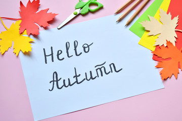 Hello Autumn concept. Making maple leaf from colored paper with your own hands for decoration of greeting card. Handmade crafts. Children's DIY. Copy space.