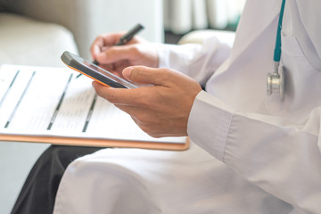 Obraz na płótnie Canvas Healthcare professional medical doctor using tablet and smartphone for consult patient via online: Physician working tele-consultation: Hospital e-healthcare professionalism Digital health concept.