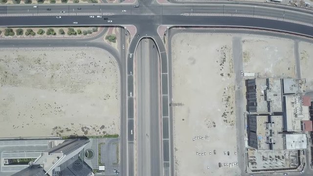 Aerial top down view of cars on a bridge and highway in Khobar. 4K video