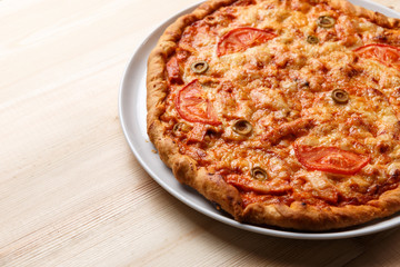 Homemade pizza on wooden table. Copy space