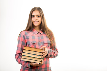 Girl with many books.  student holds a large stack of books. Education. Printed books, study at school. Library. Beginning of studies at the Institute. 
