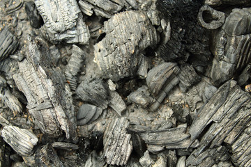 Black dry charcoal. Close-up. Background. Texture.