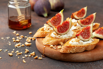sandwich with ricotta, figs and honey on a brown background