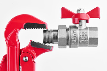 Red gas key and valve for sanitary equipment on the white background. Plumbing concept..