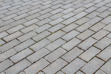 Sidewalk of cobblestones. View diagonally. Close-up. Background. Texture.